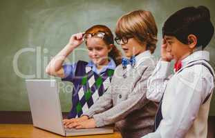 School kids using laptop in classroom