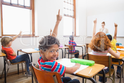 Pupil raising their hands during class