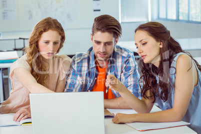 Fashion students looking at laptop