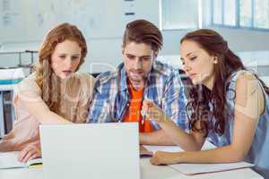 Fashion students looking at laptop