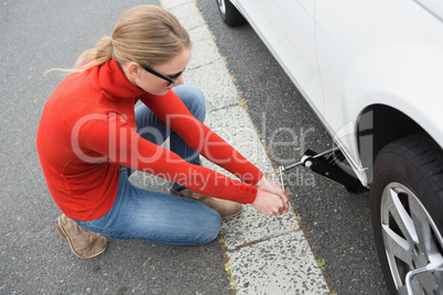 Woman replacing tire