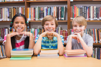 Cute pupils looking at camera in library