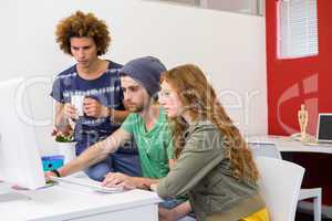 Team looking at computer screen in office