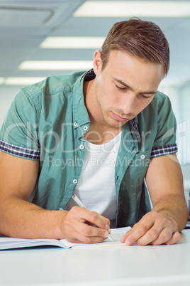 Student taking notes in class