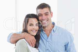 Loving couple smiling at home