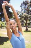 Fit woman stretching in the park