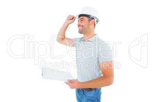 Manual worker wearing hardhat while holding clipboard