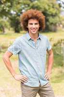 Young man smiling at camera in park