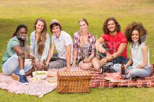 Happy friends in the park having picnic