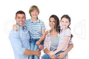 Happy parents carrying children over white background