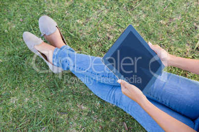 Woman using tablet in park