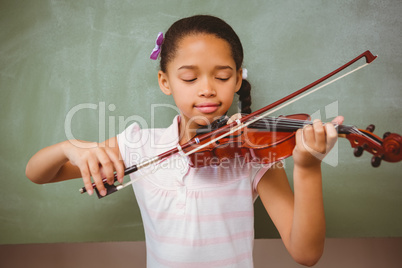 Portrait of cute little girl playing violin