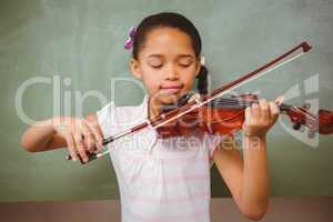 Portrait of cute little girl playing violin