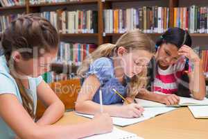 Cute pupils drawing in library