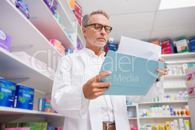 Concentrated pharmacist reading documents