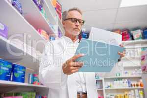 Concentrated pharmacist reading documents