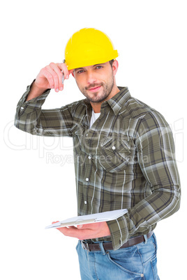 Smiling handyman writing on clipboard