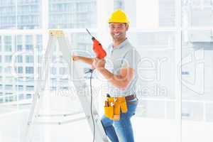 Repairman with drill machine climbing ladder in building