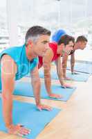 Group of men working on exercise mat