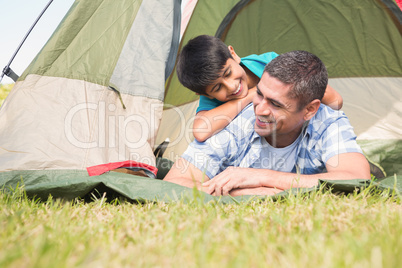 Father and son in their tent in the countryside