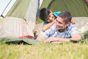 Father and son in their tent in the countryside
