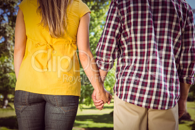 Couple holding hands in the park