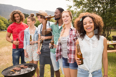 Happy friends in the park having barbecue