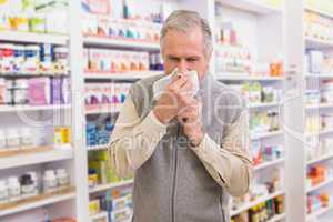 Sick customer sneezing on tissue