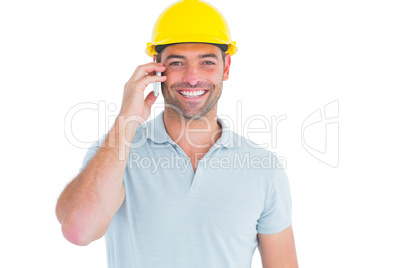 Smiling handyman talking on mobile phone