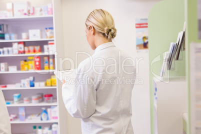 Junior pharmacist holding clipboard