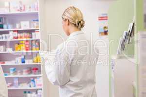 Junior pharmacist holding clipboard
