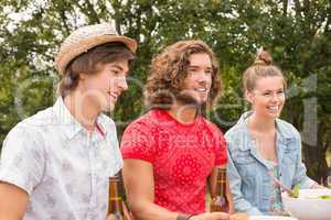 Happy friends in the park having lunch