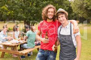 Happy friends in the park having barbecue