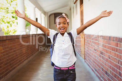 Girl stretching hands in school corridor