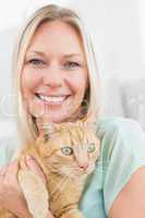 Woman holding cat at home