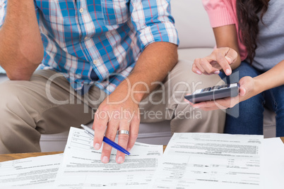 Couple calculating finances at home