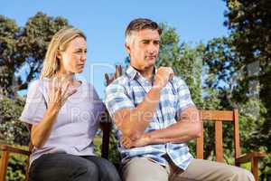 Couple having an argument on park bench