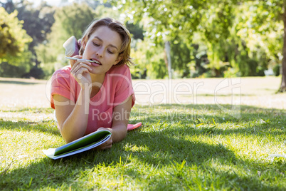 Pretty woman reading book in park