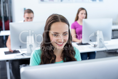 Smiling female student in computer class