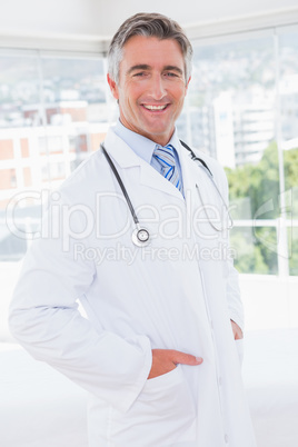 Doctor smiling at camera with hands in pockets