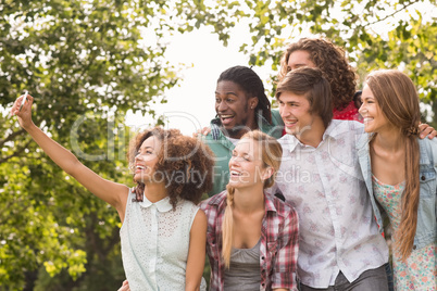 Happy friends in the park taking selfie