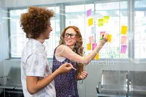Creative business team pointing at adhesive notes