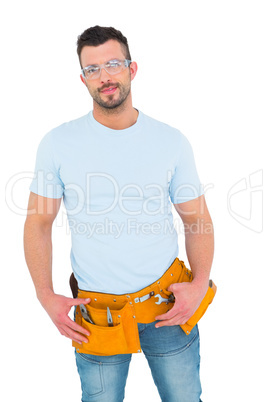 Smiling handyman with hands on hips