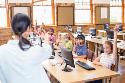 Cute pupils in computer class with teacher