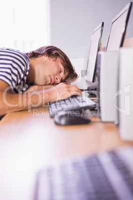 Student sleeping on computer in classroom