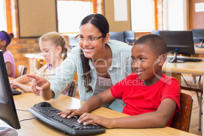 Cute pupils in computer class with teacher