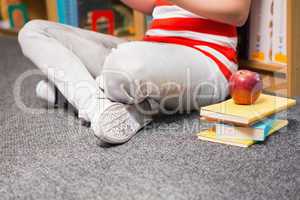 Student sitting on floor in library