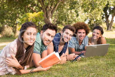 Happy friends in the park studying