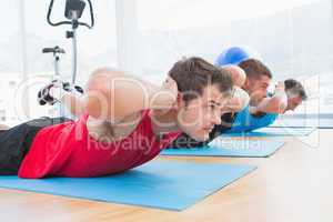 Group of men working on exercise mat