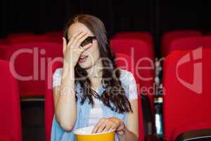 Young woman watching a scary 3d film